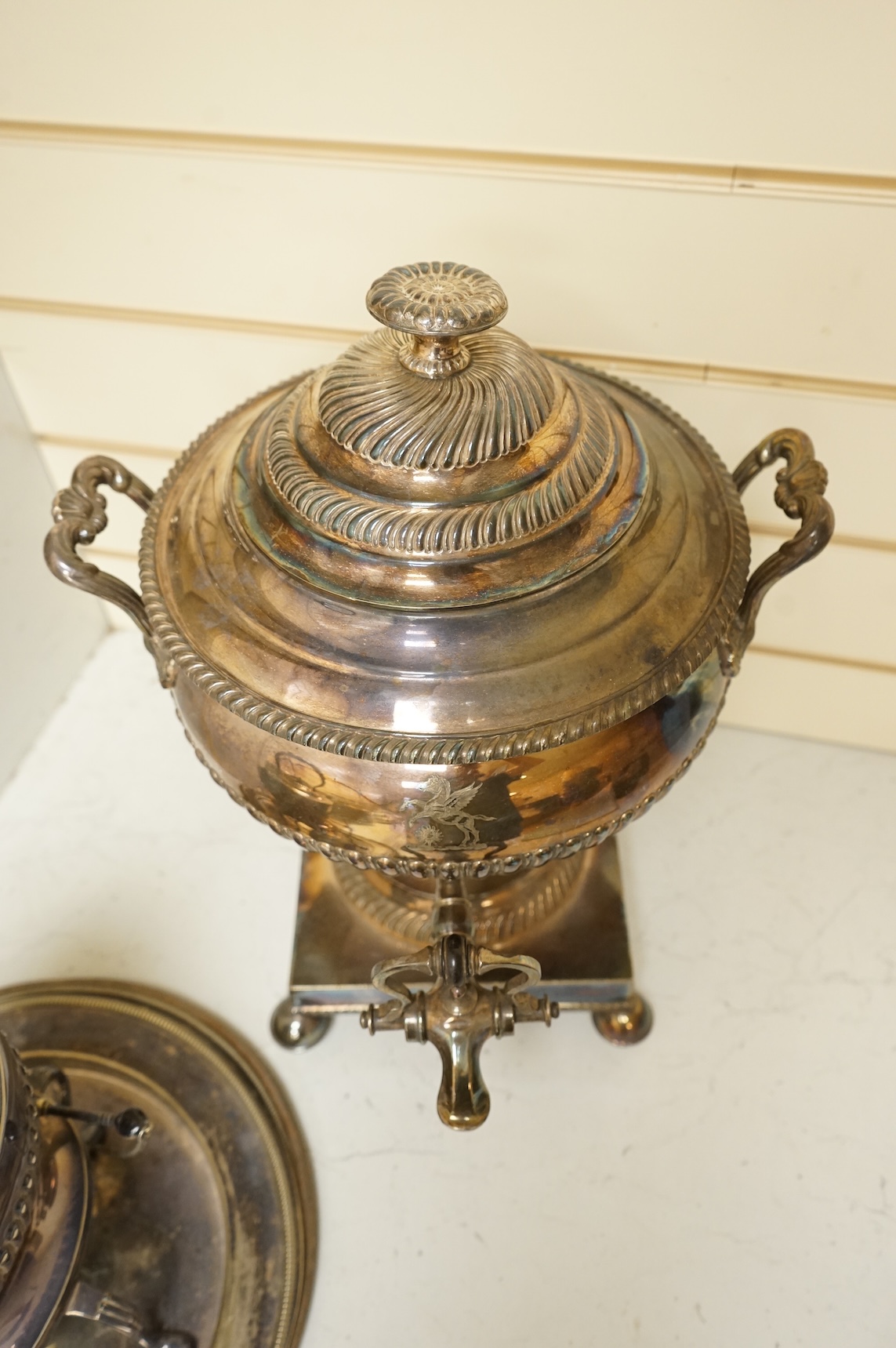 A Victorian silver plated urn, height 42cm, a silver plated spirit kettle and two circular dishes.